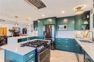 a kitchen with green cabinets and a stove at Nederland Mountain Haven bungalow in Nederland