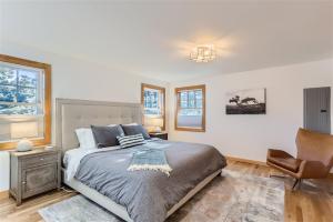 a bedroom with a bed and a chair at Nederland Mountain Haven bungalow in Nederland +20 photos