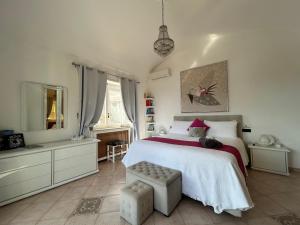 a bedroom with a large bed and a mirror at MARVELOUS SEA VIEW VILLA in Capri