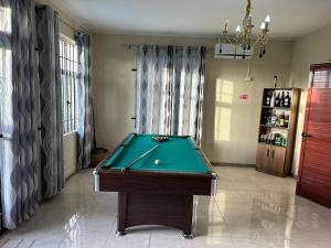 a pool table in a living room with at Eleganz Residence in Grand-Baie