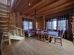 a dining room with a table and a bunk bed at Smuku Muiža in Remte