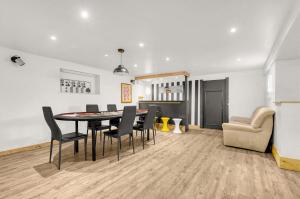 a dining room and living room with a table and chairs at Villa Rose - Padel - Piscine - Cinéma & Poker Room in Saint-Jory +24 photos