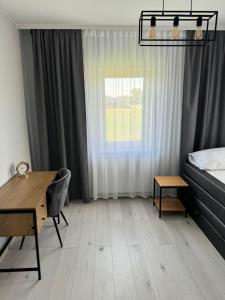 a bedroom with a desk and a bed and a window at # Marysieńka in Busko-Zdrój