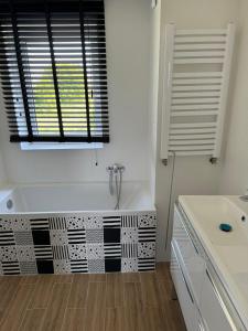 a white bathroom with a tub and a window at # Marysieńka in Busko-Zdrój +10 photos