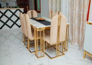 a dining room with a table and chairs at appartement 2 crepin in Pointe-Noire