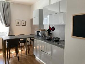 a kitchen with a counter and a table with chairs at Ca' La Bella Vita in Mestre