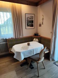 Habitación con mesa, silla y ventana en Apartmenthaus Bader en Leutasch