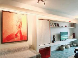 a living room with a large painting on the wall at Lefkada Eli's amazing beach house in Nikiana