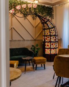 a living room with a couch and a stained glass window at Hotel Korona Wellness, Rendezvény és Borszálloda in Eger