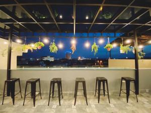a row of stools at a bar with a view at Đình Vũ 3 MOTEL in Hai Phong