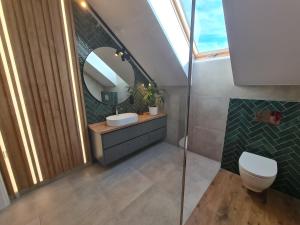 a bathroom with a sink and a mirror at Zacisze in Kamień Pomorski
