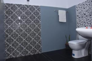 a bathroom with a shower with a toilet and a sink at Ocean Gate Residence in Bentota +35 photos