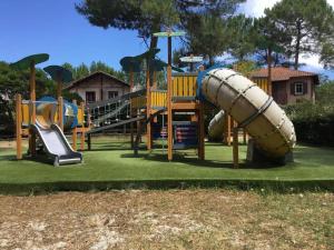 a group of playground equipment on a lawn at Appartement à 2 pas océan et lac in Lacanau