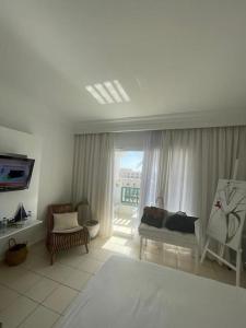 a living room with a couch and a window at Appartement Sur La Plage in Hammamet +6 photos