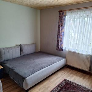 a bed in a room with a large window at Haus Klaus in Großlobming