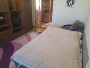 a bedroom with a bed with a pillow on it at Апартаменти біля Автовокзалу in Rivne