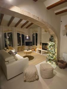 a living room with a christmas tree and a white couch at Casa El Sueño in Jávea