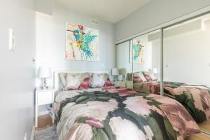 a bedroom with two beds and paintings on the wall at GLOBALSTAY Maple Leaf Square in Toronto