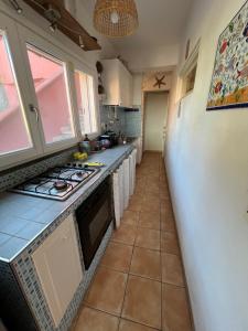 a kitchen with a sink and a stove top oven at Casa vista Castello in Capraia