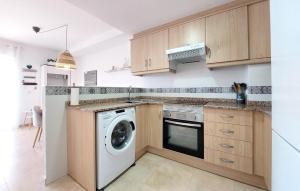 a kitchen with a washing machine and a washer at 2 Bedroom Gorgeous Apartment In Moncofa in Moncófar
