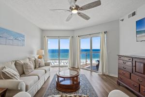 a living room with a couch and a view of the ocean at Emerald Isle Unit 607 in Pensacola Beach