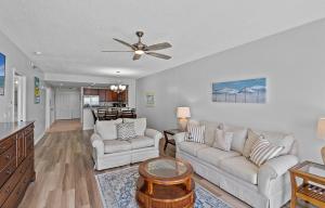 a living room with two couches and a ceiling fan at Emerald Isle Unit 607 in Pensacola Beach +32 photos