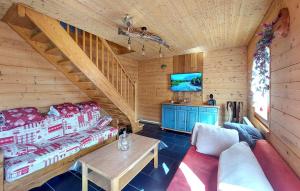 a living room with a couch and a table in a cabin at 5 Bedroom Nice Home In Xonrupt-Longemer in Xonrupt-Longemer