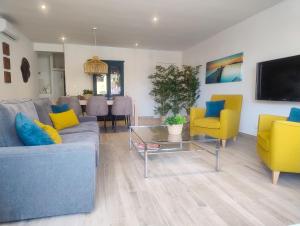 a living room with a couch and chairs and a table at Apartamento Aura in Jávea
