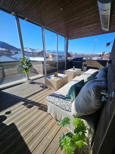 a bedroom with a bed on a boat with windows at Platinum VIP - Aurora luxury house in Tromsø
