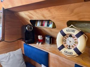 a bed with a clock on a wooden wall at LA REGINA in Lido di Ostia