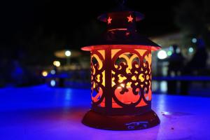 a red lantern sitting on a table at night at Villaggio Camping Oasi in Vieste
