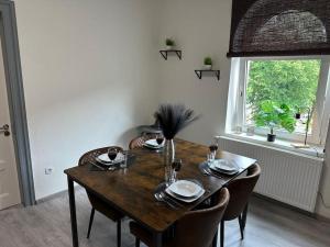 a dining room table with chairs and a window at FeWo Topnik in Castrop-Rauxel