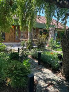 a house with a garden in front of it at Charming place in the nature-Casita Iris in Bijeljina