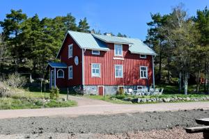 a red barn on the side of a road at Strandhugget BnB in Sottunga