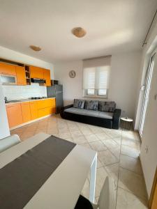 a living room with a bed and a kitchen at Apartmani Maja Vrsi in Vrsi