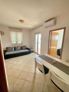 a living room with a couch and a table at Apartmani Maja Vrsi in Vrsi