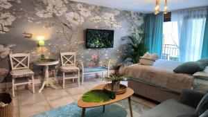 a living room with a bed and a table and chairs at Centre Budva Blue in Budva