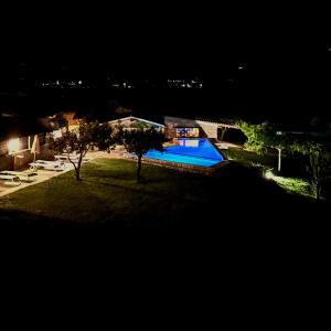 an aerial view of a swimming pool at night at Quinta do Nobre in Marialva