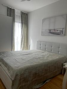 a bedroom with a bed and a painting on the wall at Dream in Sibenik in Šibenik