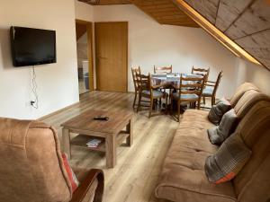 a living room with a couch and a table at Penzion Kunčice in Frýdek-Místek