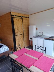 a dining room with a table and a kitchen at Tiny House in Fleury-sur-Loire