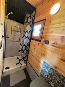 a bathroom with a shower in a tiny house at Les logements insolites de la Base Nautique in Verneuil