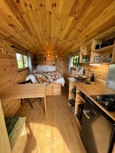 a bedroom in a log cabin with a bed at Les logements insolites de la Base Nautique in Verneuil +35 photos