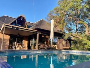 a house with a swimming pool in front of it at 22 Siyanda Mabalingwe in Mabula