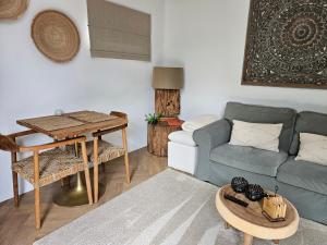 a living room with a couch and a table at Bed and Breakfast Bij ons in het bos in Bergen op Zoom
