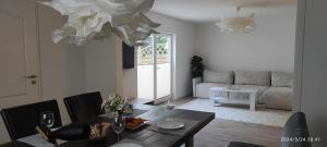a living room with a table and a dining room at Lilli Flensburg Fewo in Flensburg