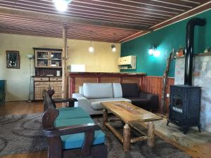 a living room with a couch and a stove at Studio Katerina in Florina