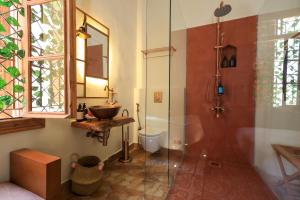 a bathroom with a glass shower and a sink at Beit Toureef in Beirut