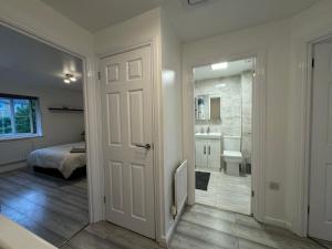 a white bathroom with a shower and a sink at Spacious 3 bedroom Home, with private driveway 5 minutes from Excel Centre & Custom House in London +21 photos