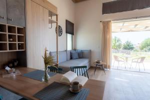 a living room with a table and a couch at Apolithon Premium Houses in Sígrion